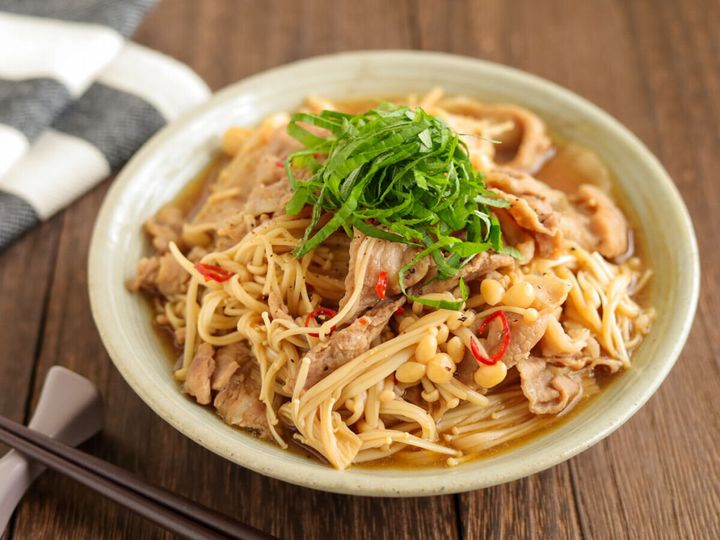 箸が添えられた、青じそと粗びきこしょうがトッピングされた豚こまえのき