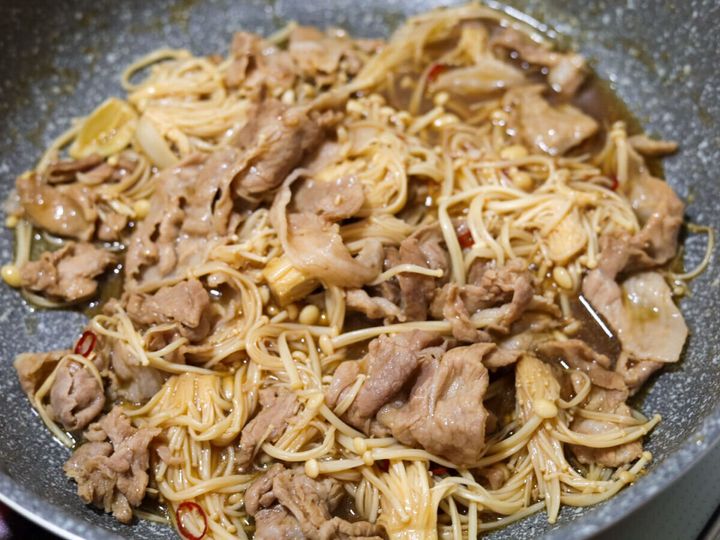 フライパンの中で豚肉とえのきが煮詰められ、全体に煮汁が絡んでいる様子