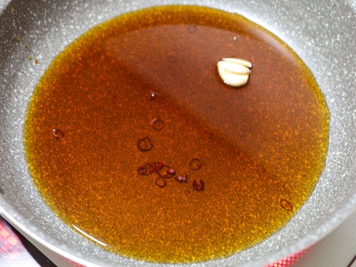 フライパンにしょうゆ、酒、みりん、酢、水、にんにく、赤唐辛子が入った煮汁
