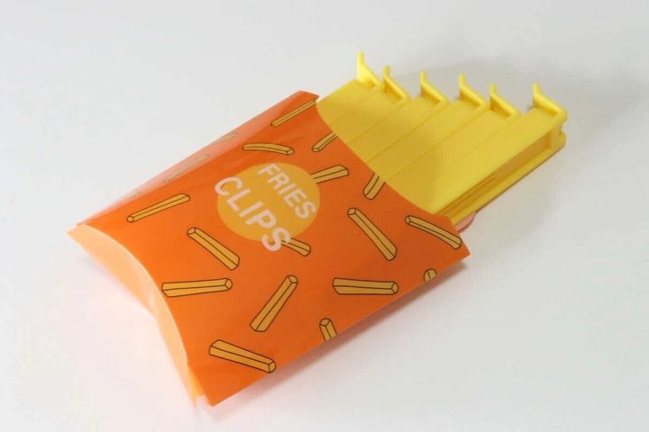 フライドポテトの容器に黄色いクリップが収まっている