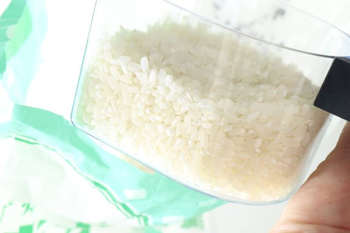 計量カップの側面にある0.5合の目盛りと米