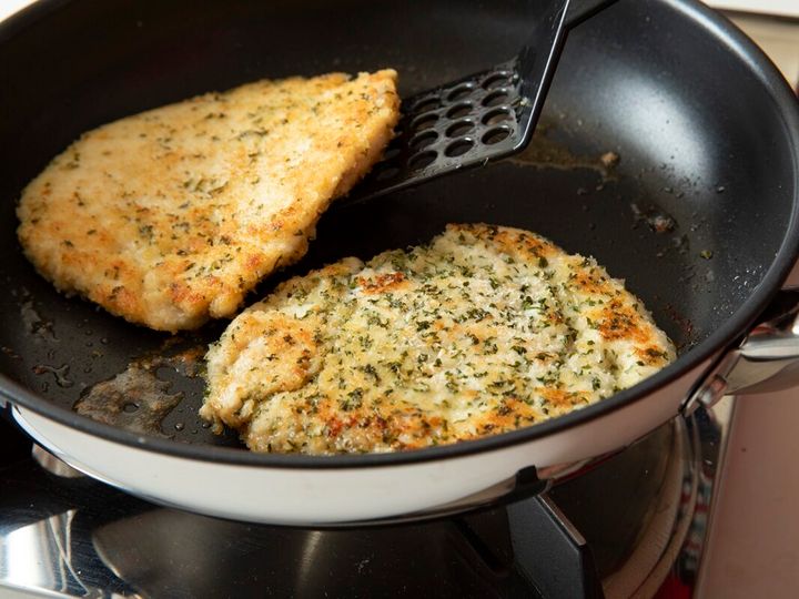 パン粉をつけたひき肉を、フライパンでこんがり焼いている