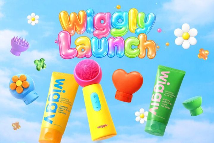 「wiggly Launch」の文字と、黄色・緑のチューブやブラシが空に浮かぶwigglyのビジュアル