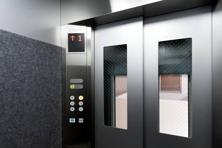 操作盤と小窓のついた、エレベーター内部の扉。