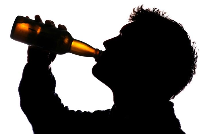 Man drinking bottle of cider silhouette