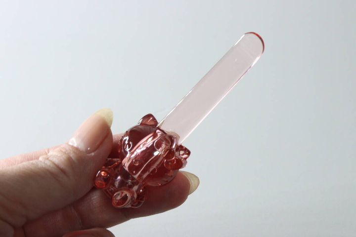 ピンク色のハローキティ立つスパチュラを指で持っている様子