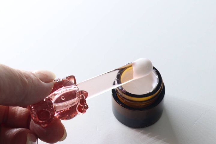 ハローキティ立つスパチュラでジャーコスメをすくっている様子