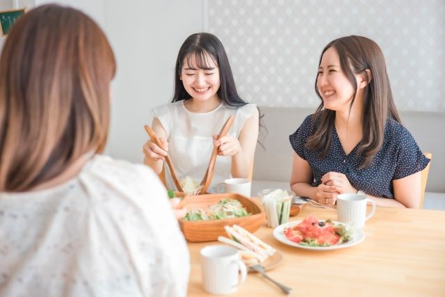 大皿料理の取り分けを楽しむ食事の場面