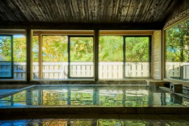 大きな窓の向こうに緑が広がる「ONSEN f」。客室風呂とはひと味違う、開放感のある湯浴みが楽しめる