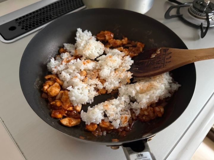 木べらでご飯と具材を混ぜ合わせる
