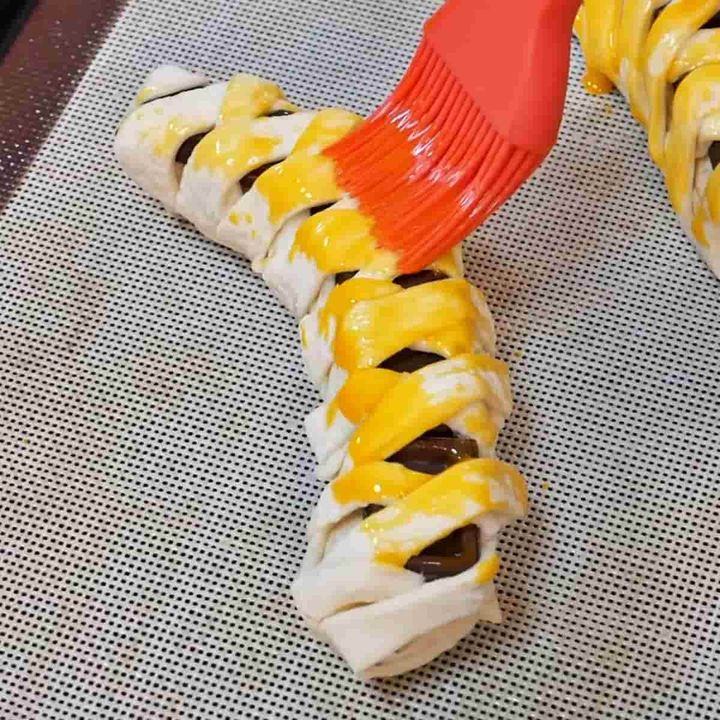 成形したチョコバナナロールパイに卵黄を塗った様子