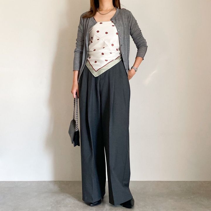 グレーカーデと黒ワイドパンツの女性がドット柄スカーフをベアトップ風に着る