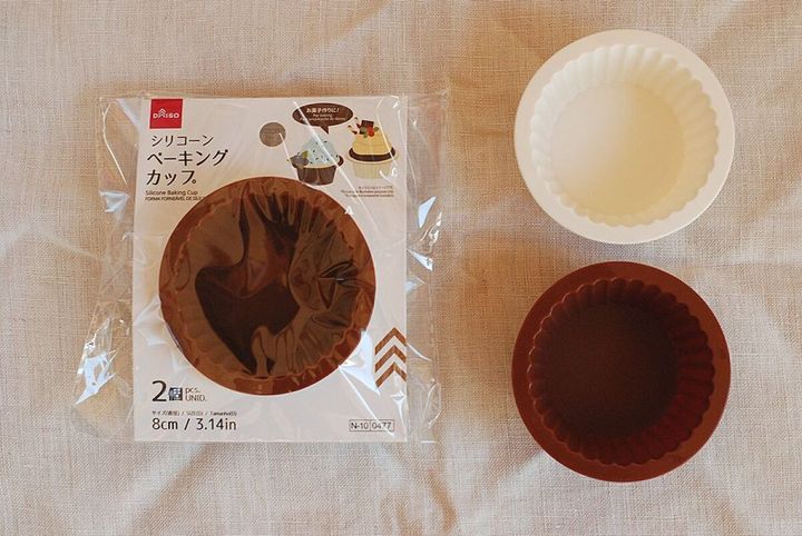ダイソーのシリコーンベーキングカップのパッケージと白と茶色のカップが並べられた様子
